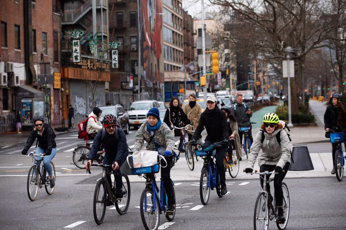 Cyclists riding down a New York street closed to cars